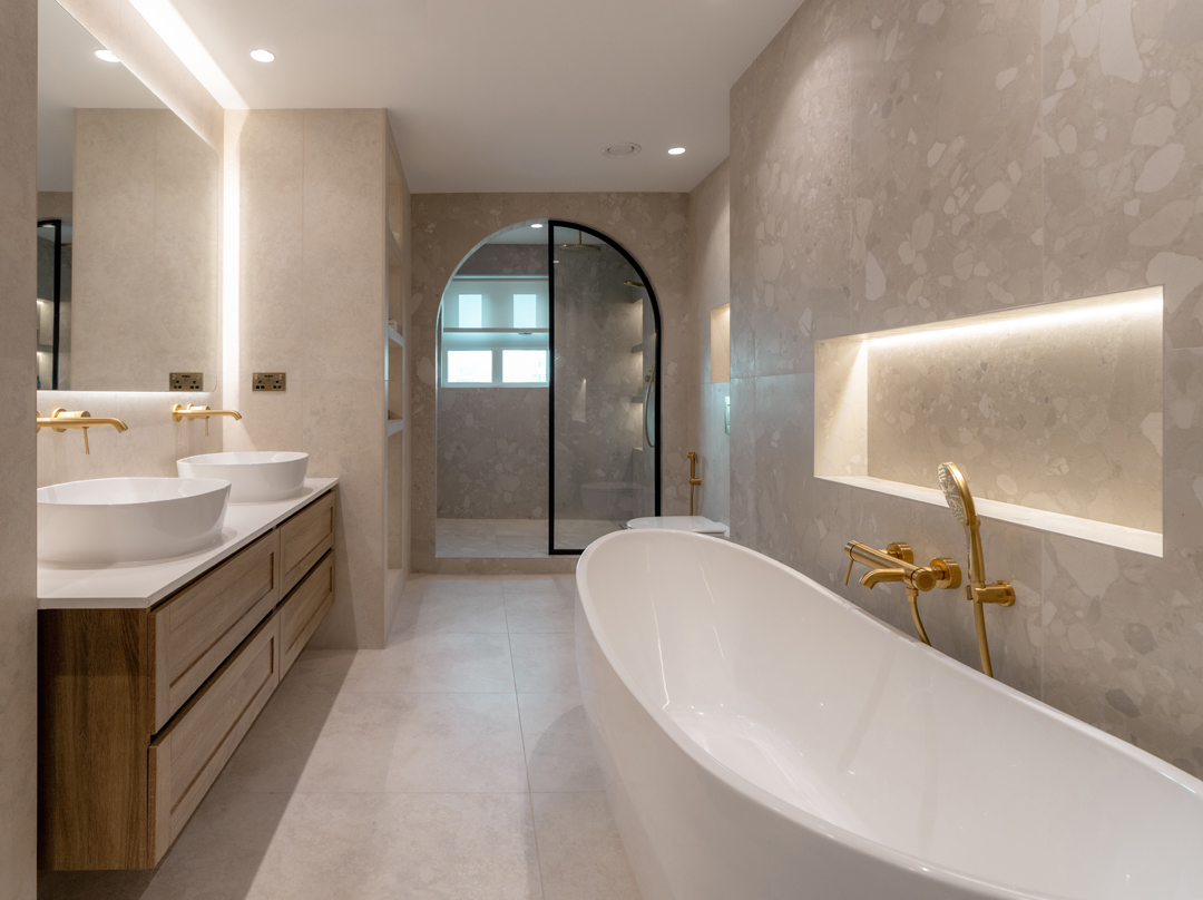 Fit-out contractors in Dubai design luxurious bathrooms with floating vanities, gold fixtures, and ambient recessed lighting.