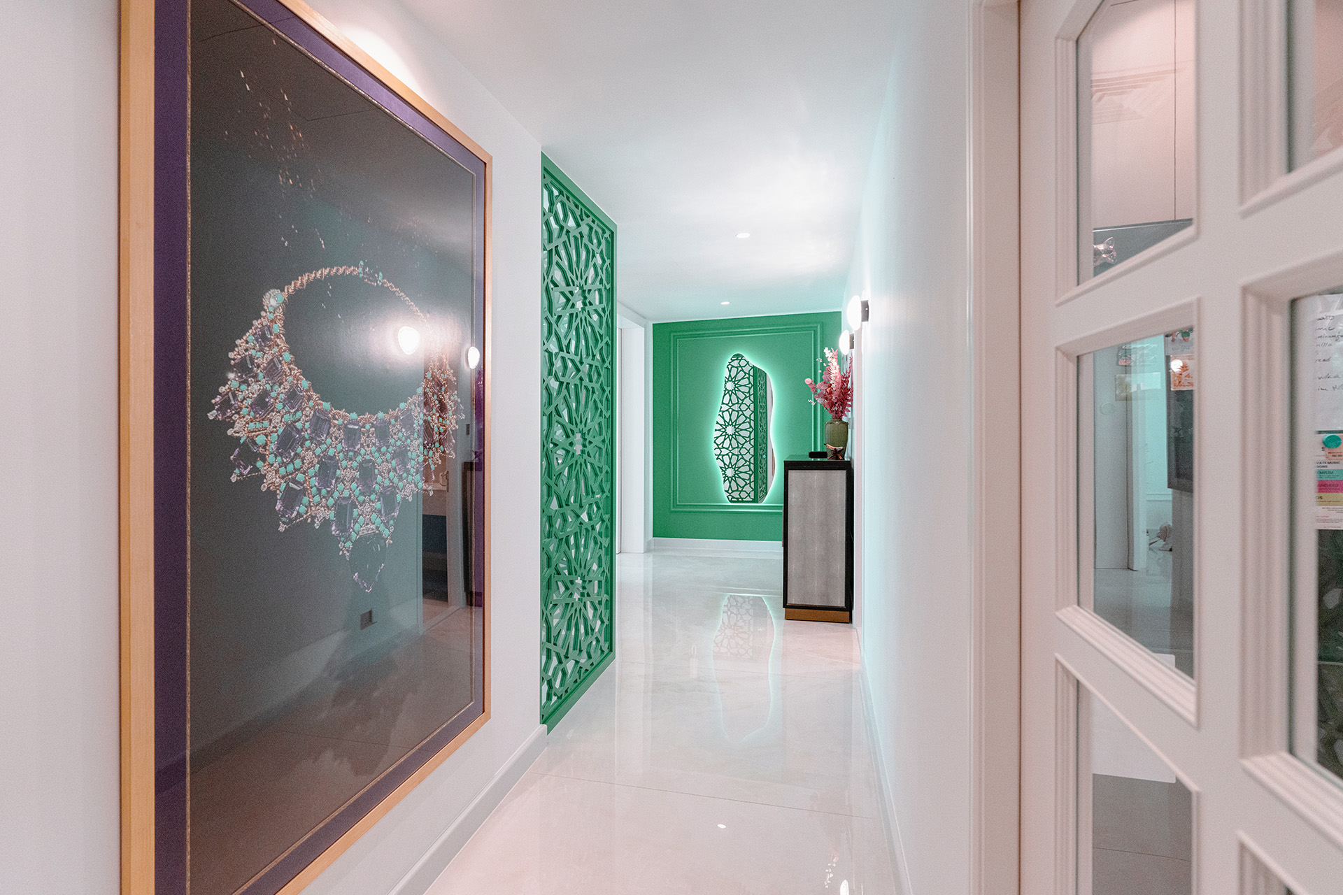 Smart Renovation used art and ornate structural pieces to enliven the minimalist interior design of The Sanctuary of Emerald's apartment hallway.