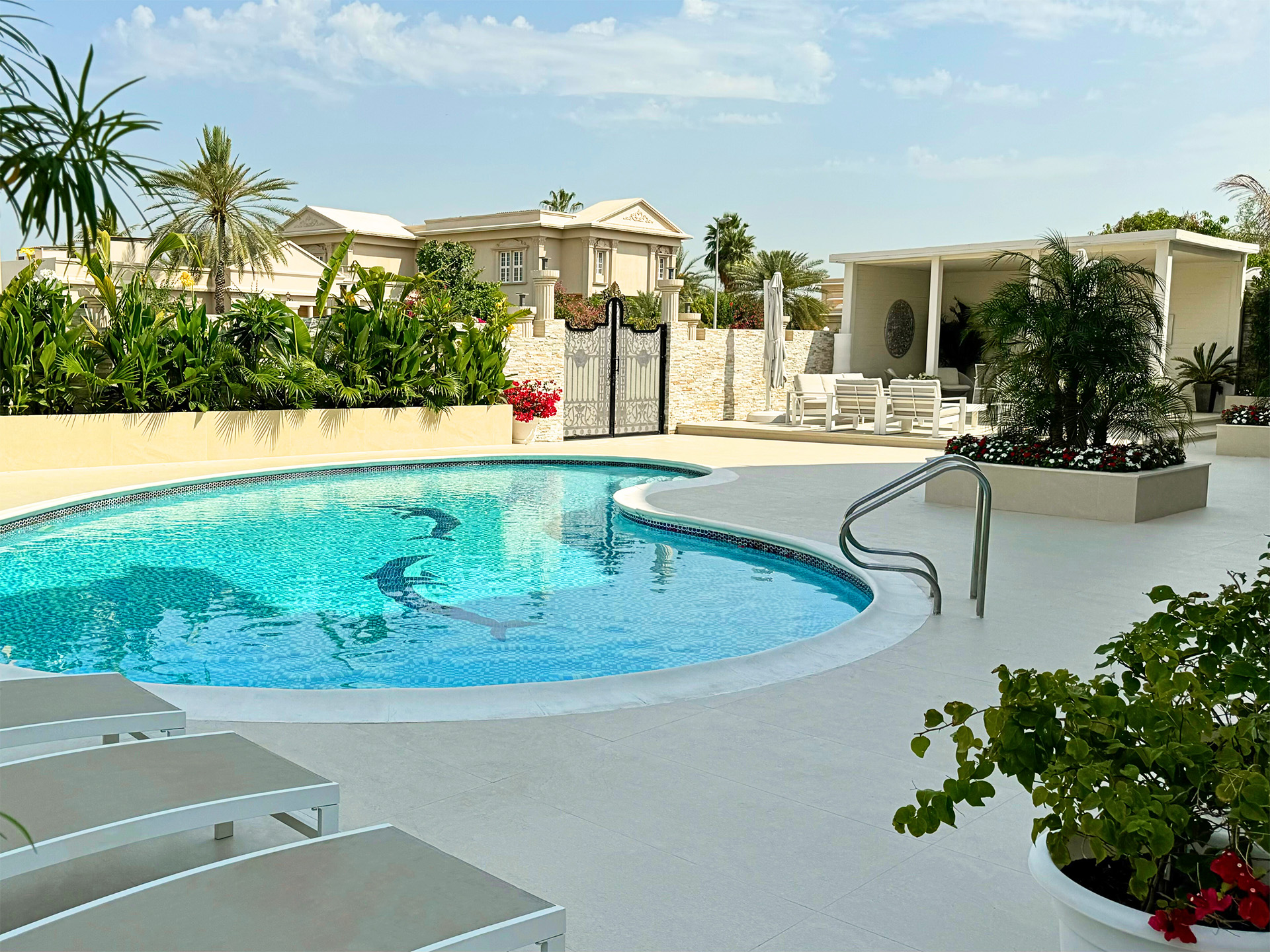 A moon-shaped pool by Smart Renovation for Miami Vibes Villa featuring elegant curves, serene water, and stylish outdoor design.