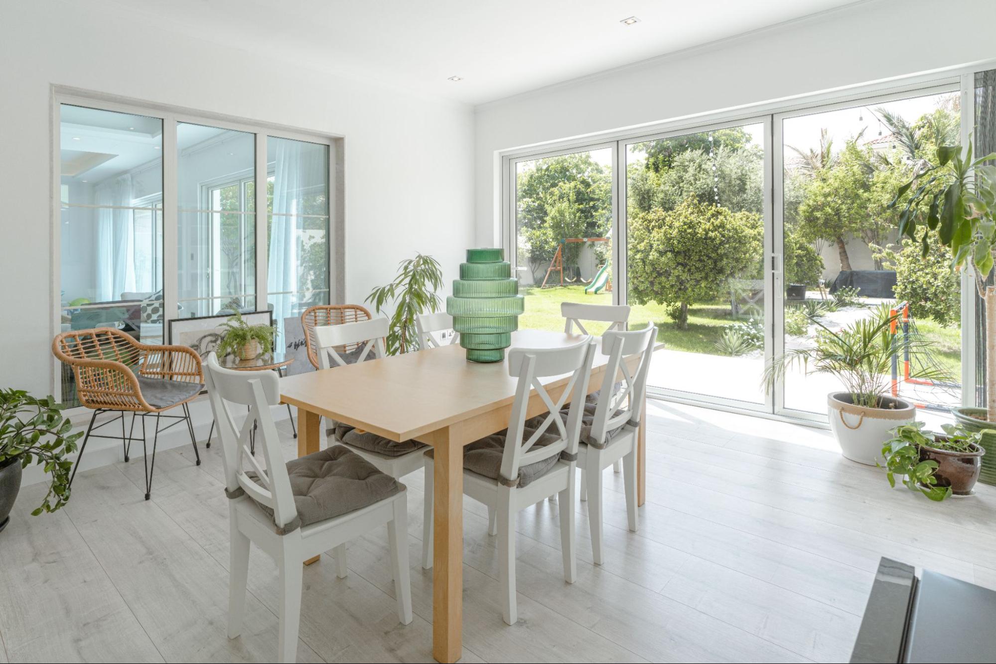 Indoor-outdoor garden flow by Smart Renovation for Casa Fiorita featuring large sliding doors, natural light, and a green outdoor view.