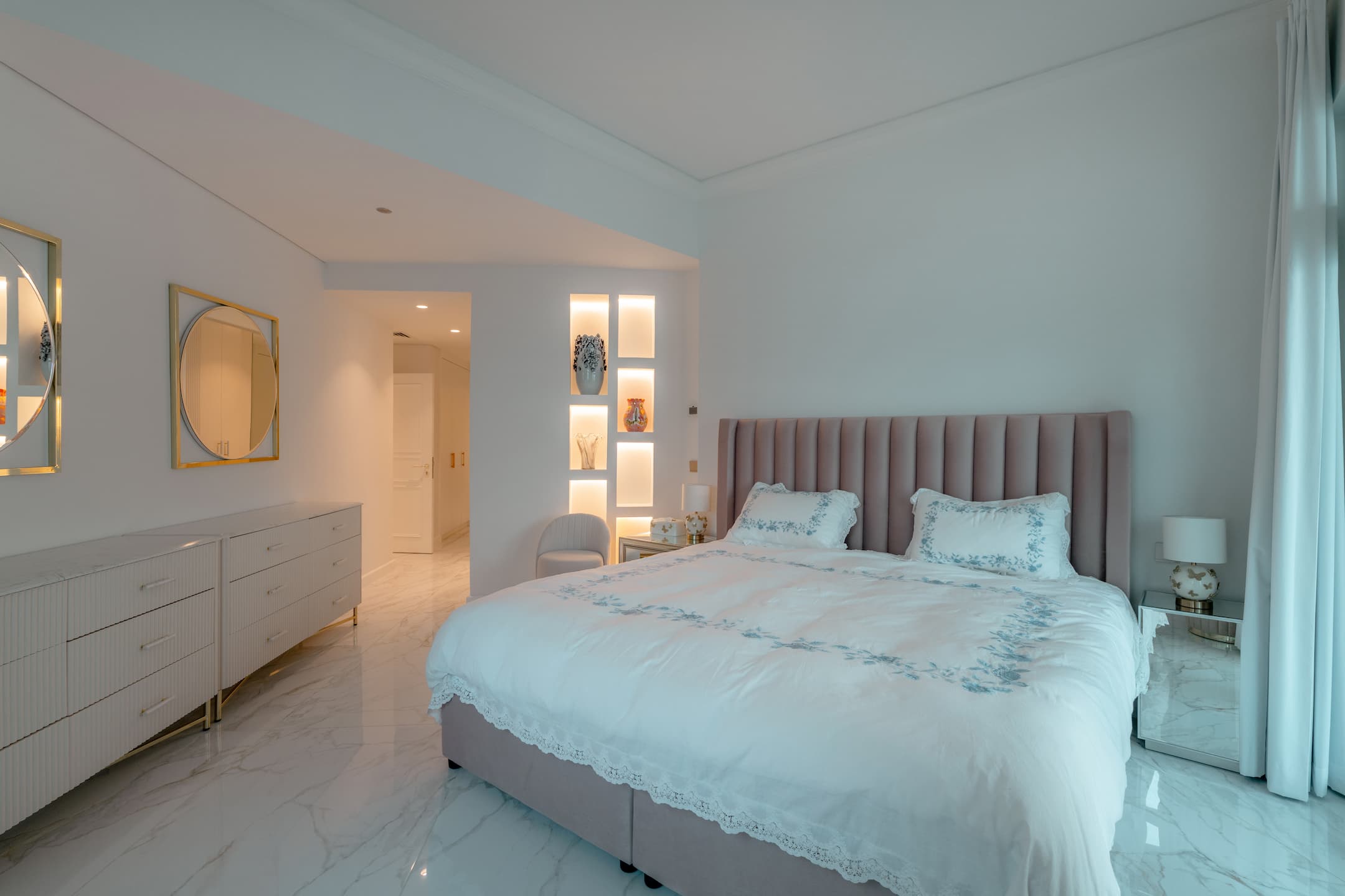 Golden Vienna villa fit-out works displaying a serene bedroom with custom lighting and a soft upholstered bed design.